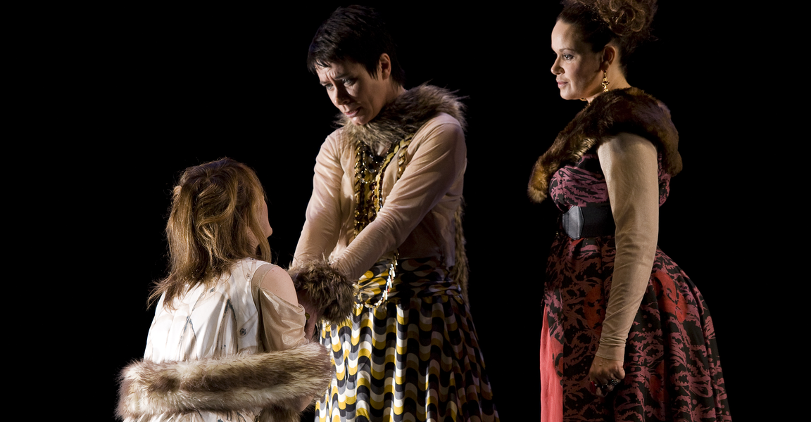 Susan is kneeling and holding Jane's hands, while Jane and Leah stand over her