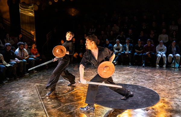 Alex King and Darius Williams in a fight scene with swords and shields on the set of King Lear, 2024.